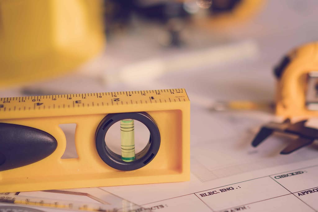 Using level to adjust refrigerator for proper door closure and alignment